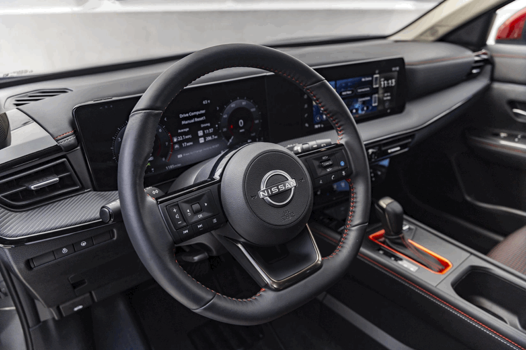 2026 Nissan Kicks cabin with steering wheel, digital screen and onboard controls.