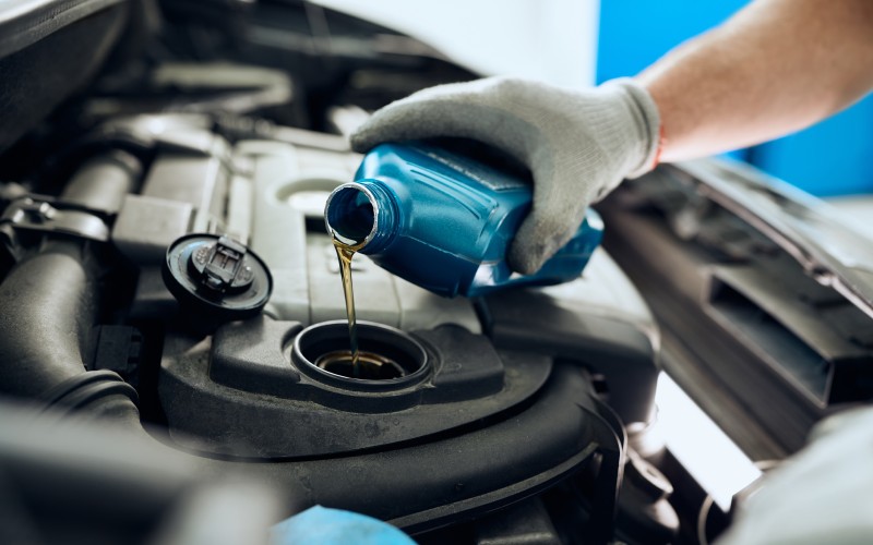 close car mechanic changing engine oil