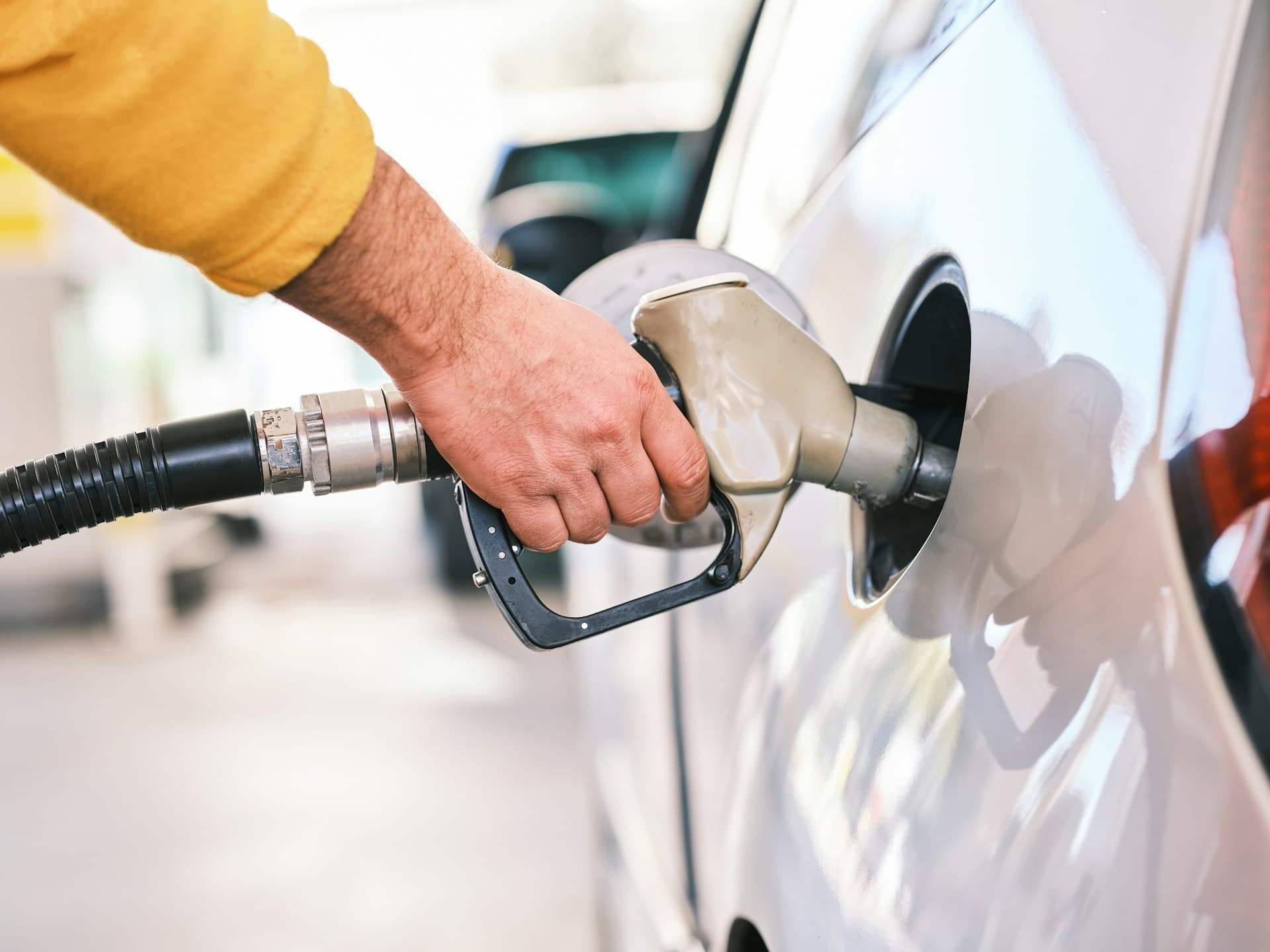 pumping gas at a gas station