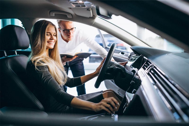 young-woman-testing-car-from-car-showroom